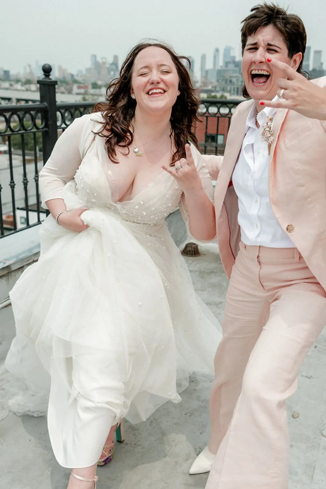 Newlyweds laughing on the rooftop terrace