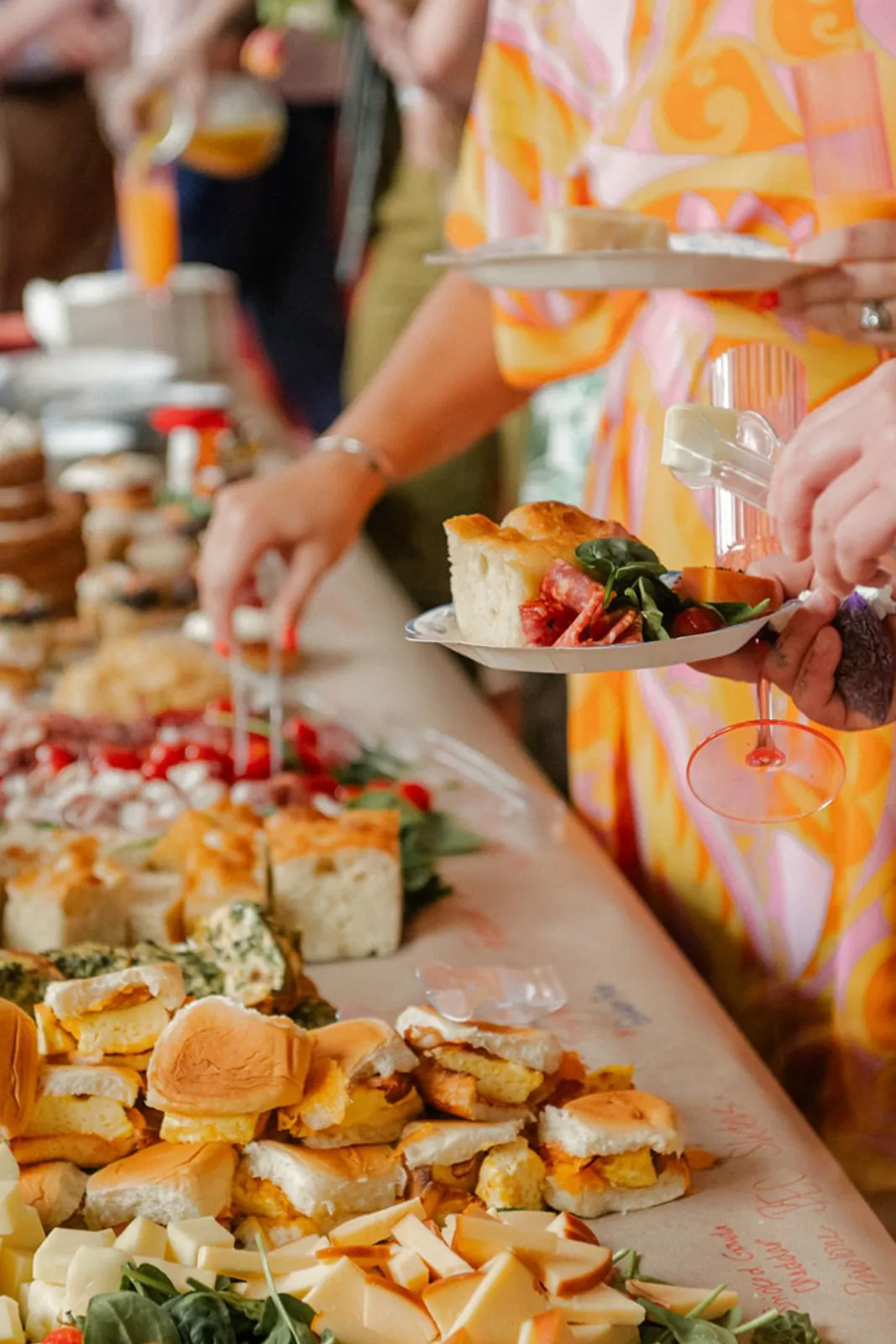 Platter of sliders and appetizers being served at an event