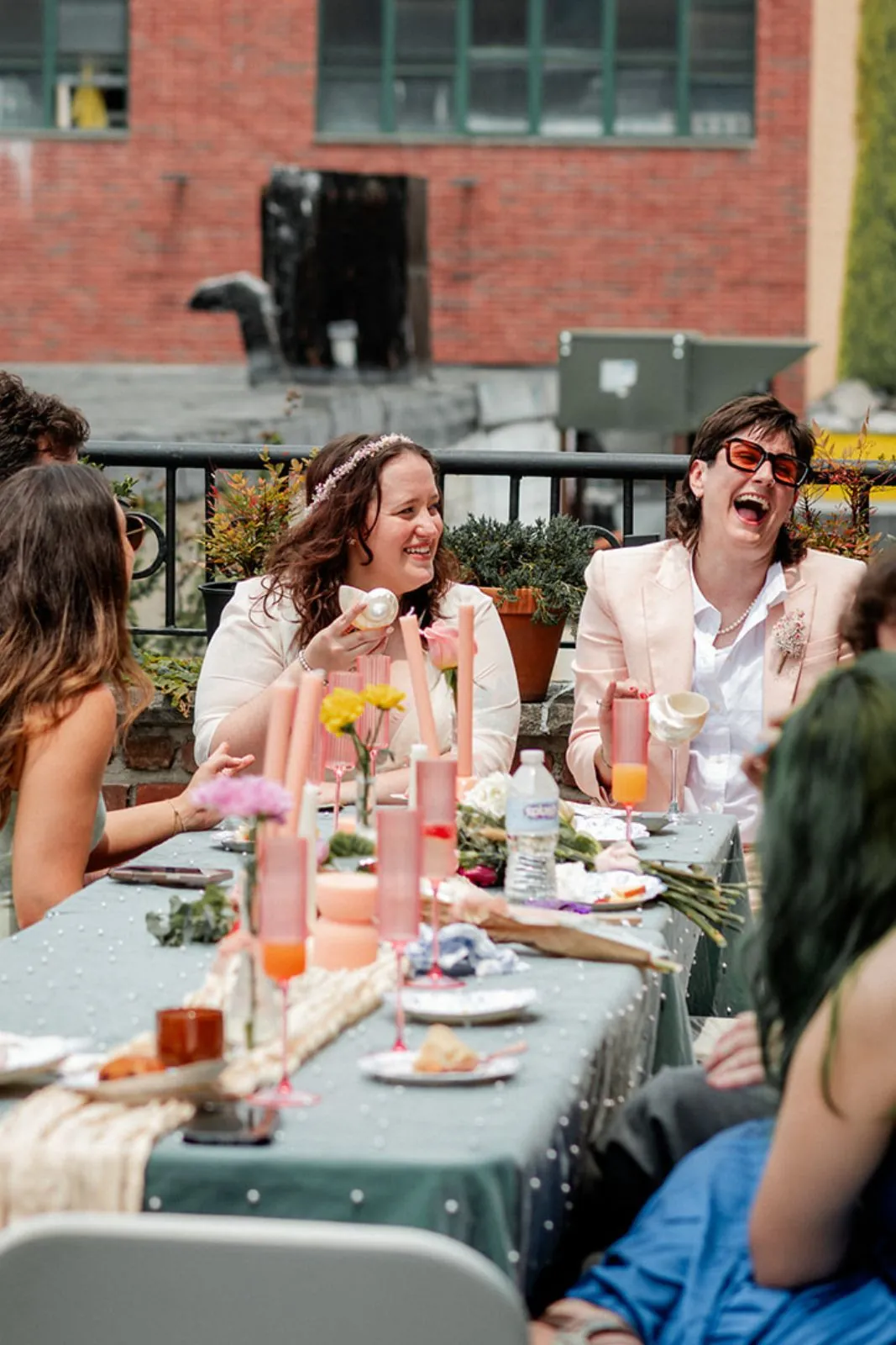 Couple laughing at a reception table on the terrace
