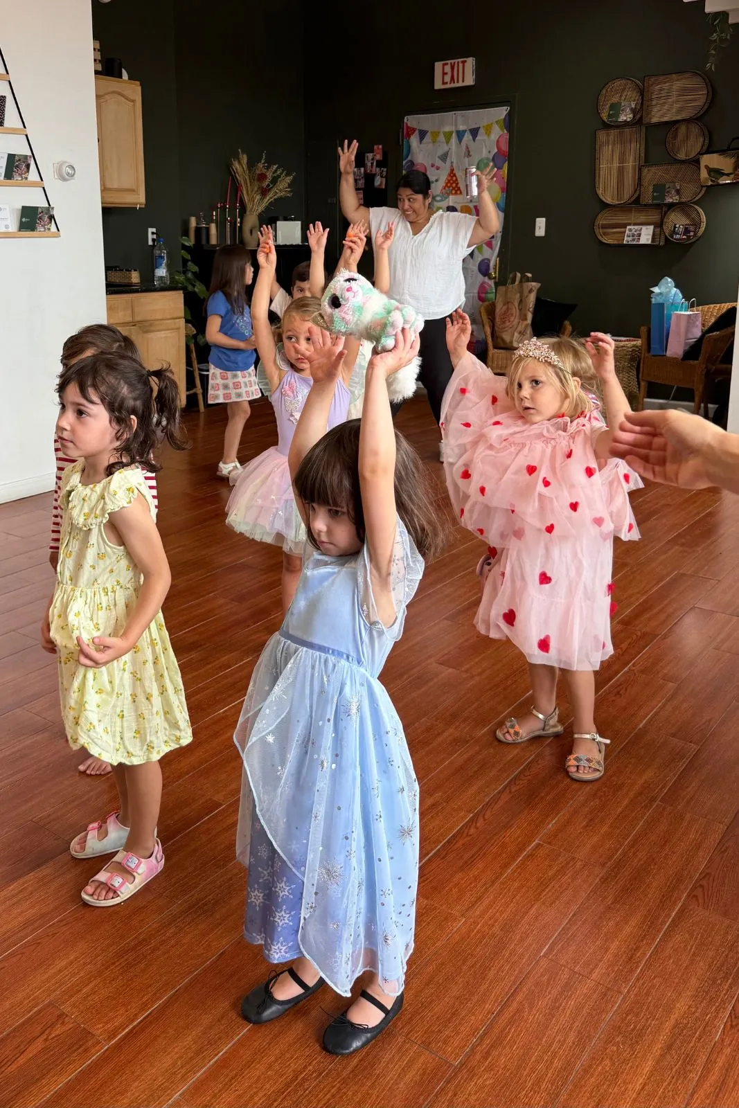 Kids dance party with arms in the air