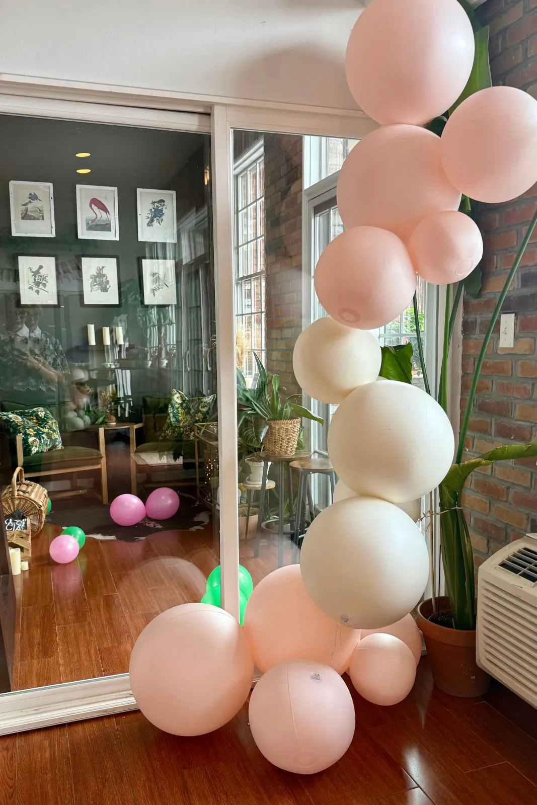Pastel balloon column beside a mirror