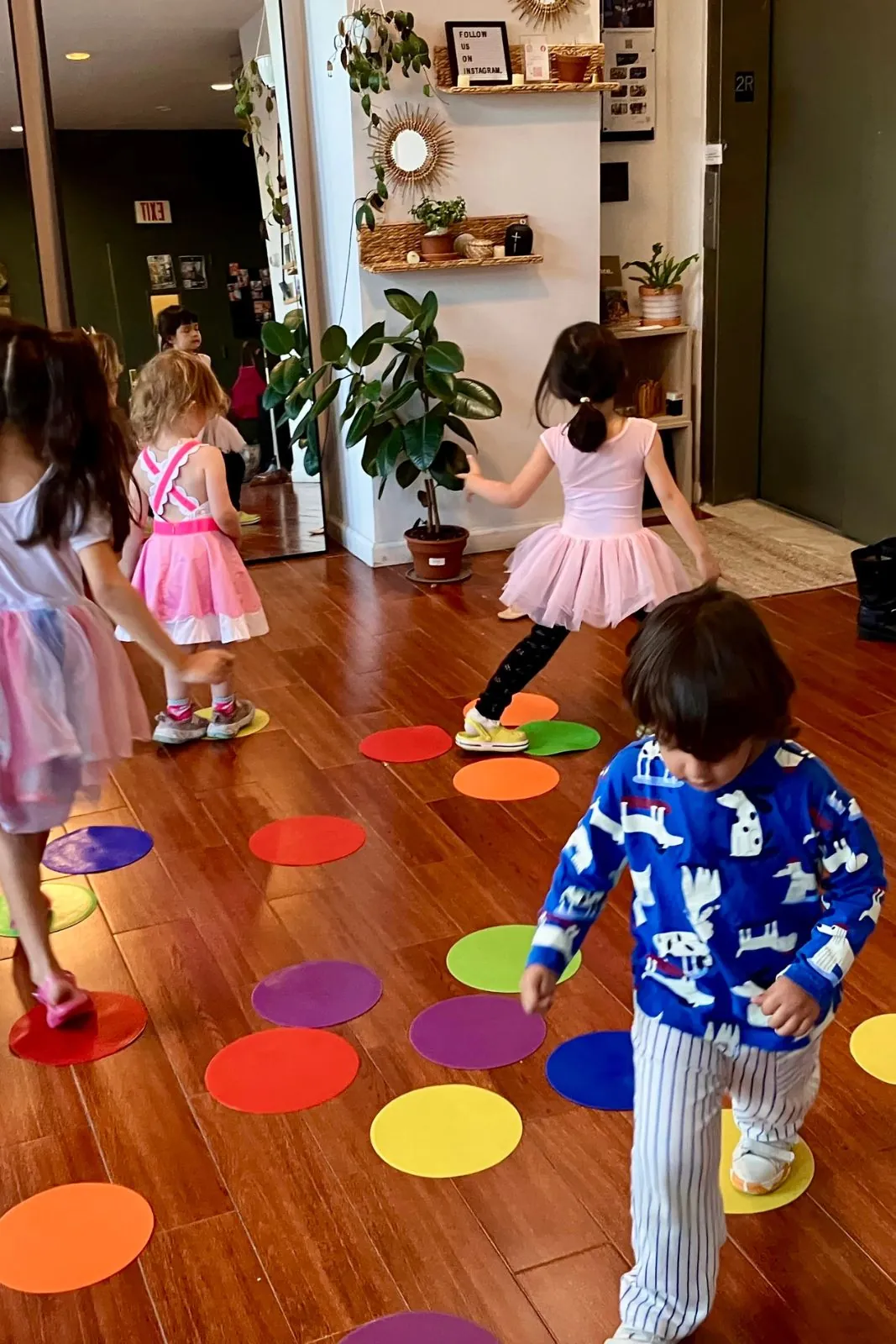 Kids playing on colored floor dots