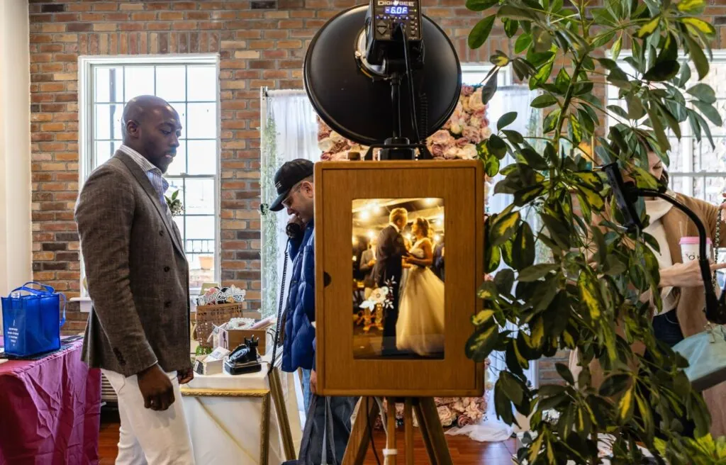 Guest in a suit standing beside a photo booth