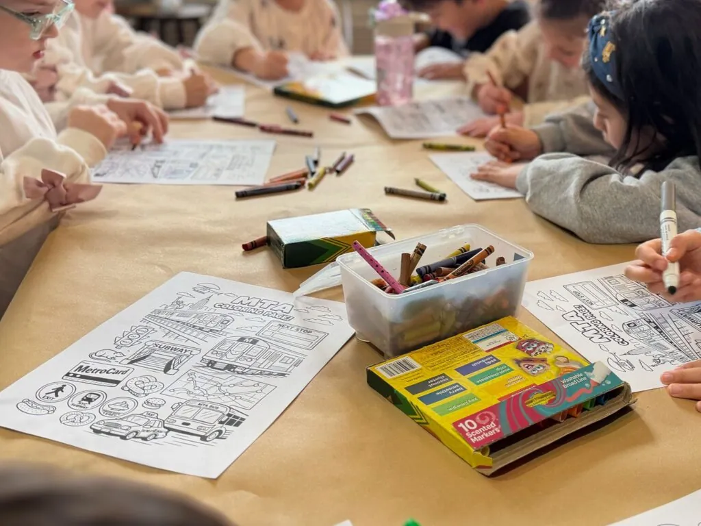 Kids coloring and crafting at a party table