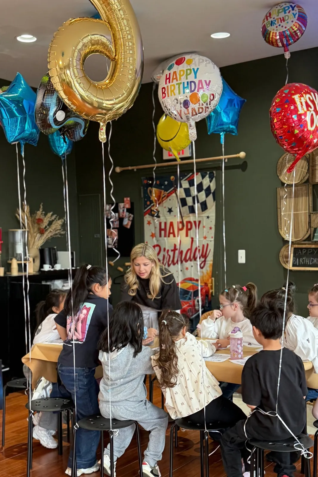 Kids' birthday party with balloons and a Happy Birthday banner