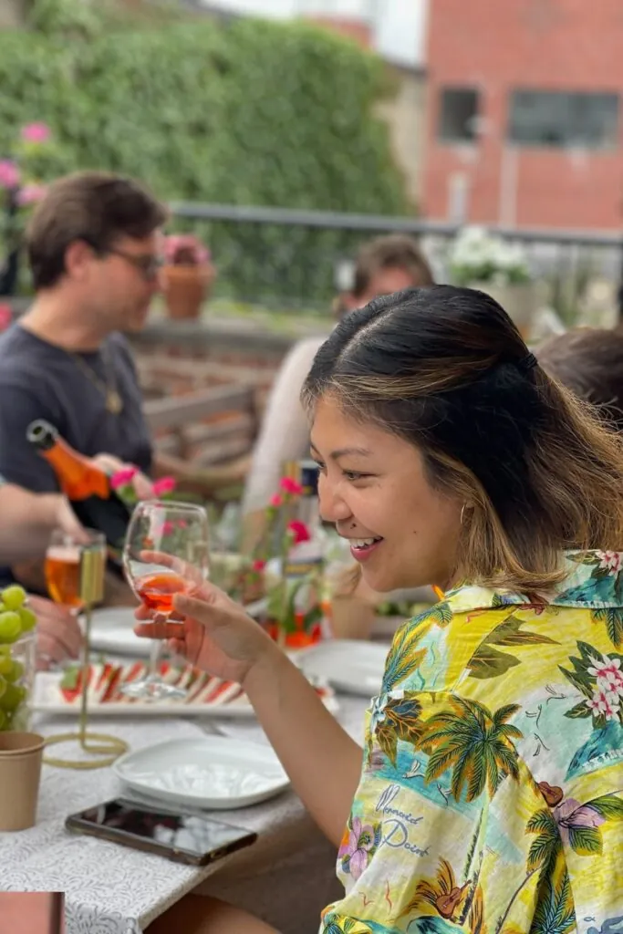 Guest laughing at a table on the terrace