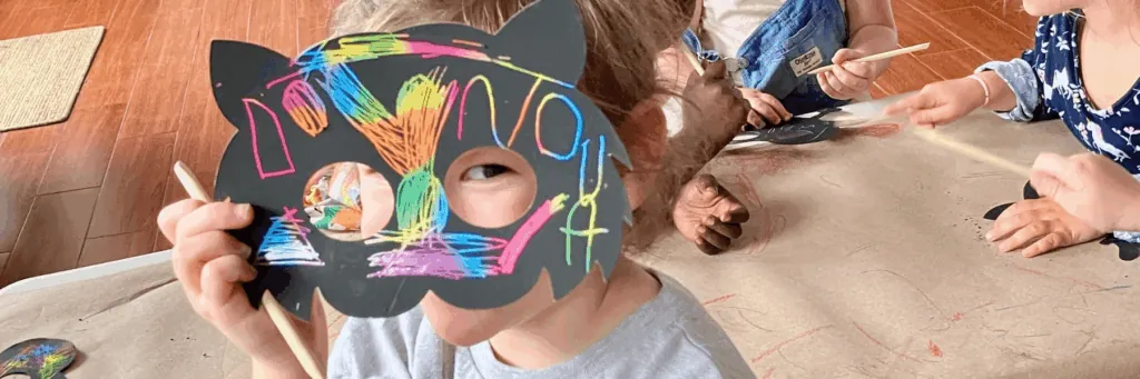 Child wearing a decorated animal mask (Animals theme)