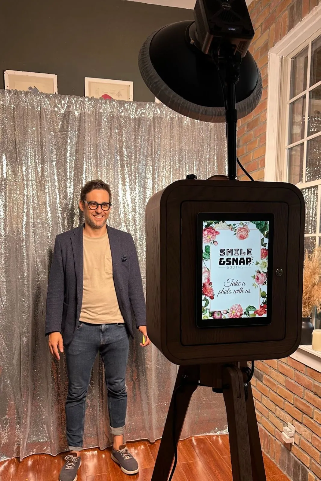 Photo booth with a guest standing next to it