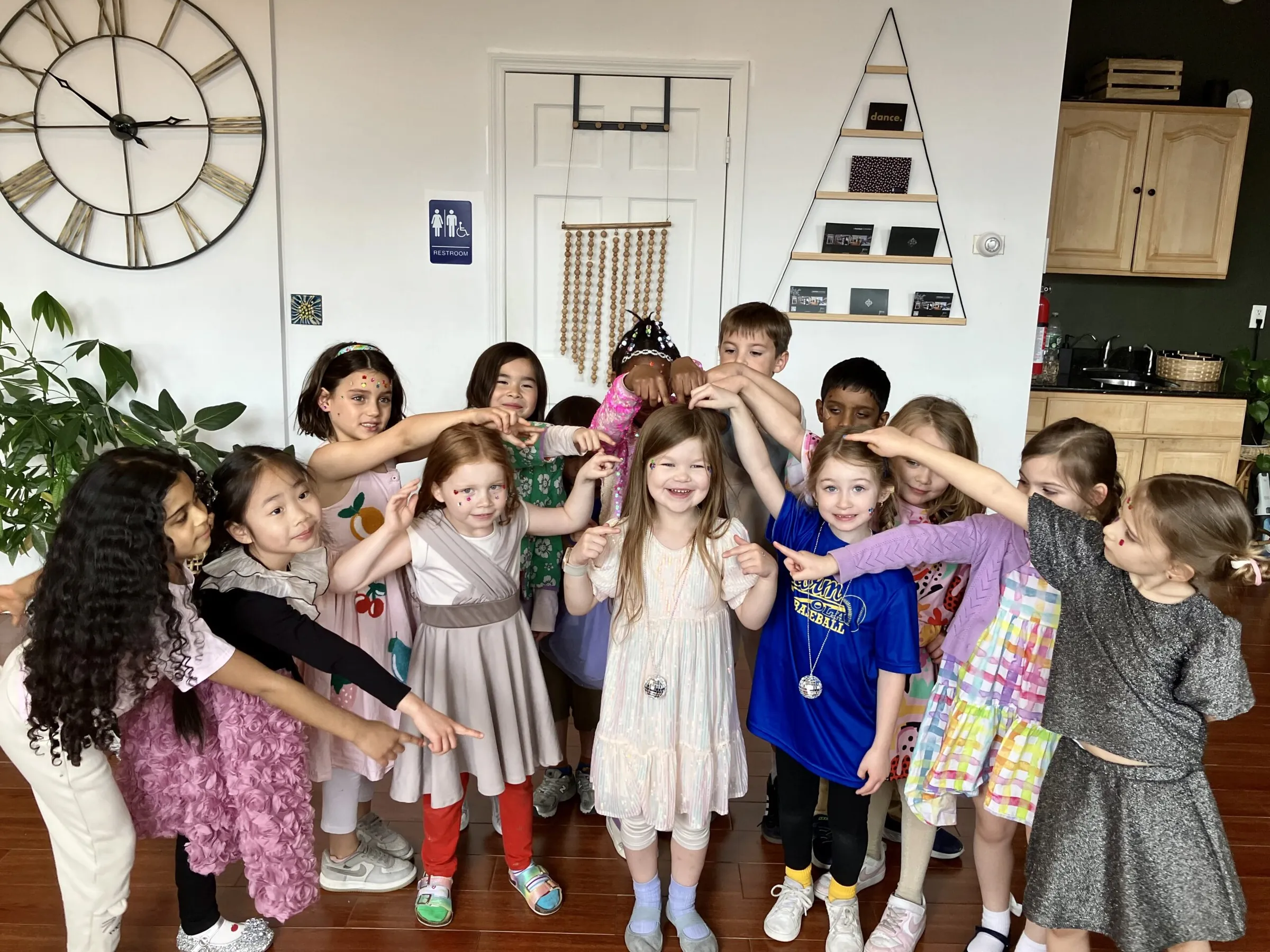 Children posing with their arms around each other at a kids party