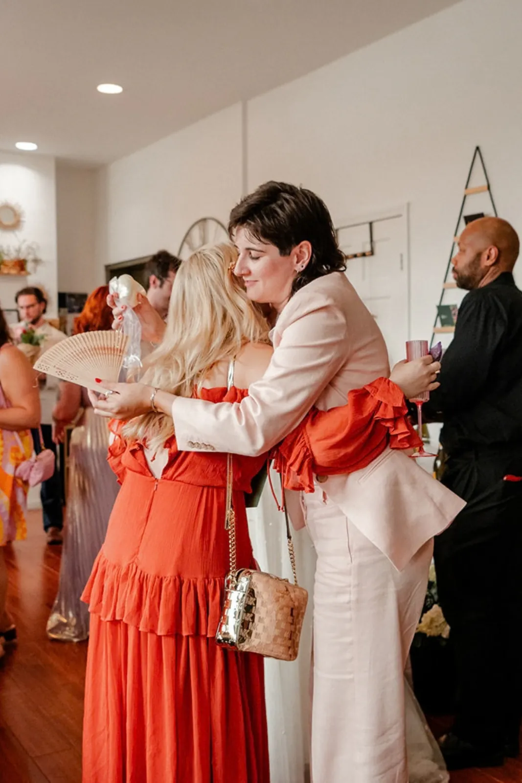 Two guests embracing at an event