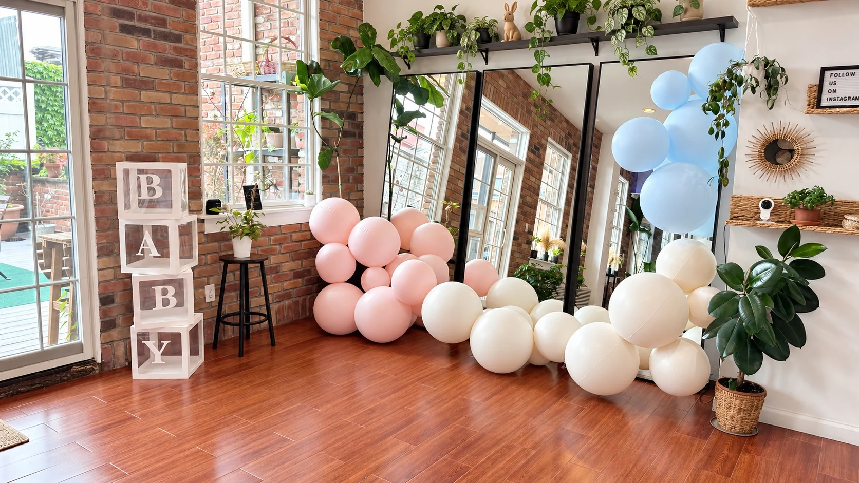 BABY letter blocks and blush, ivory and blue balloon garlands in front of mirrors at Green Boutique